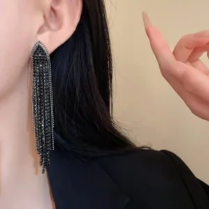 Detailed close-up of elegant long black rhinestone triangle tassel fringe earrings