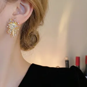 Statement irregular gold firework stud earrings featuring zircon accents on silver pins