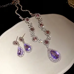 Elegant silver-tone jewelry set with purple water-drop crystal pendant and earrings