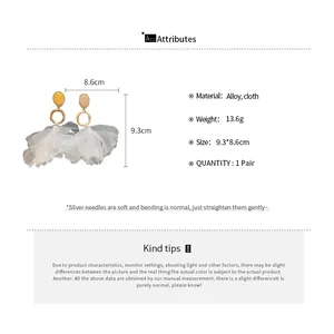 Detailed attributes of flower drop earrings with cloth petals and silver needles.