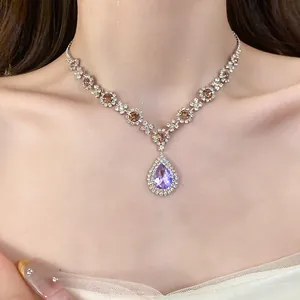 Close-up of elegant rhinestone waterdrop necklace featuring a brilliant purple crystal pendant