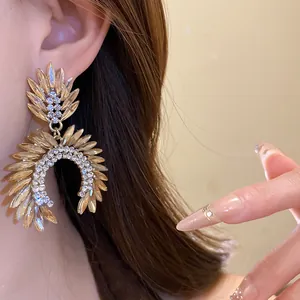 Detailed close-up shot showing champagne crystal drop earrings worn by an Asian model