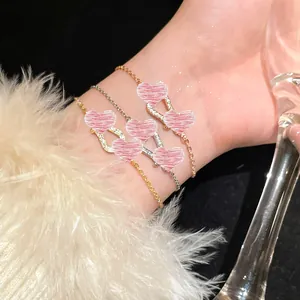 Close-up of elegant horseshoe buckle zircon bracelets on a wrist with white fur.