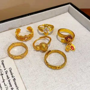 Collection of elegant gold-plated rings featuring intricate flower and gourd motifs.