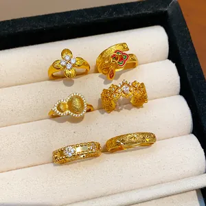Collection of luxury gold-plated rings featuring gourd and flower designs with CZ stones