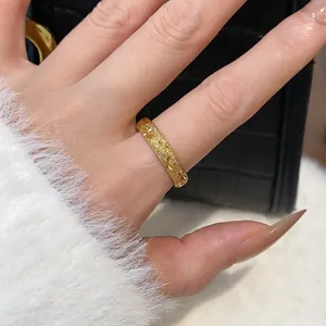 Close-up view of gold-plated ring featuring frosted texture and star patterns