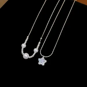 Macro view showing details of French zircon star pendant and pearl necklaces on black background