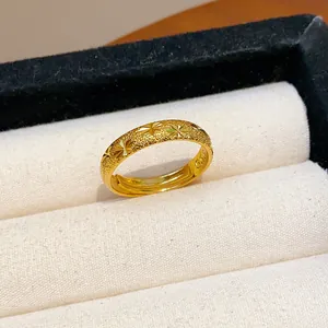 Detailed close-up of a gold-plated frosted ring featuring unique engraved star patterns