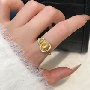 Detailed view of a gold-plated calabash ring with pavé zircons on a hand