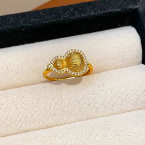 Detailed close-up of a luxury gold-plated gourd ring featuring sparkling zircon inlay