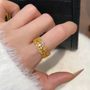 Close-up detail of a high-end gold plated ring with intricate floral and gourd designs.