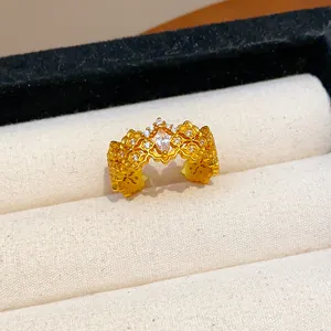 Elegant gold-plated ring with intricate hollowed floral patterns and marquise zircon.