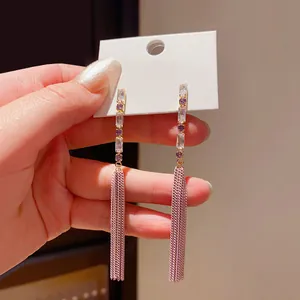 Detailed close-up view of elegant long tassel earrings with zirconia and rose gold chains