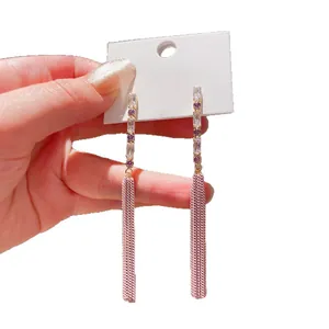 Elegant silver needle drop earrings featuring purple zircon and long chain tassels