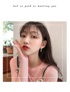 Close-up of model wearing elegant candy-colored floral tassel long drop earrings
