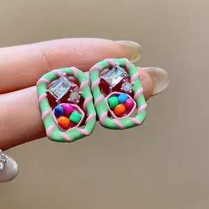 Close-up detail showing the colorful beads and crystal of the dopamine stud earrings