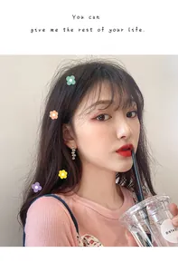 Delicate candy-colored floral tassel earrings worn by a model in a casual lifestyle setting