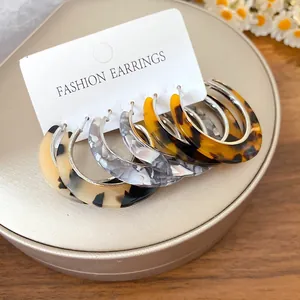 Set of three vintage tortoiseshell and marble patterned acetate C-shaped hoop earrings.