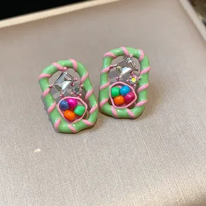 Macro detail view of dopamine style geometric earrings with colorful beads and clear crystal