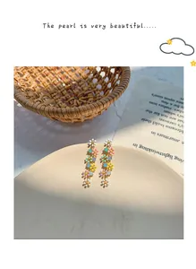 Detailed view of colorful candy-colored flower long chain tassel earrings for women.