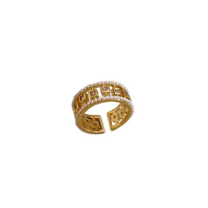 Elegant gold-plated open ring with pearls and square zirconia on a pure white background.