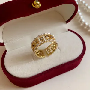 Detailed view of the intricate pearl and zircon embellishments on the golden band of the ring