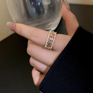 Detailed view of a retro hollow zircon ring with mini pearls on an index finger.