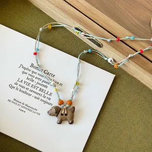 Vintage leather necklace with colorful wooden beads and a cute dog pendant accessory