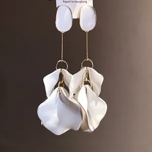 Vintage elegant white petal drop earrings with gold-tone finish and oval stud detail.