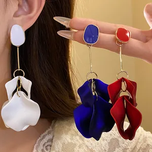 Elegant vintage petal dangle earrings shown in white, royal blue, and vibrant red