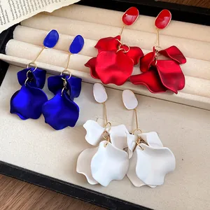 Detailed view of vintage petal dangle earrings in blue, red, and white colors