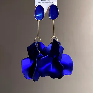 Detailed macro view of elegant deep blue petal drop earrings with golden accents