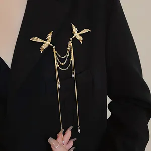 Detailed macro view of a golden phoenix brooch with pearl tassels worn on a black suit