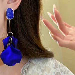 Detail shot of royal blue oval petal drop earrings with elegant silver needles