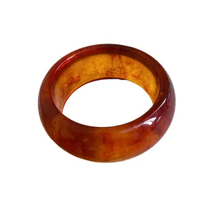 Vintage marbled amber resin bangle bracelet with a minimalist round design