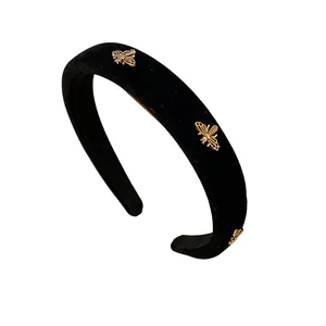 Elegant black velvet padded headband decorated with three golden honey bee charms for women