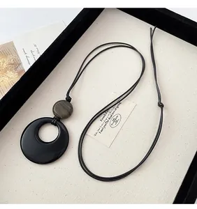 Vintage black hoop and wood bead pendant necklace with adjustable leather cord strap