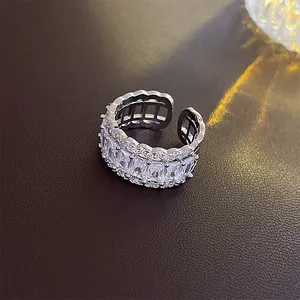 Detailed close-up of a geometric open ring featuring emerald-cut clear cubic zirconia stones