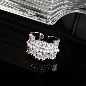 Macro view of silver plated ring with sparkling baguette zirconias and white pearls