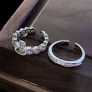 Close-up of zircon open rings with iconic saturn crown and channel-set crystal details