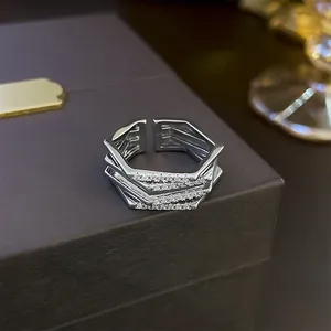 Macro detail showing geometric silver ring with multi-layer zirconia inlay