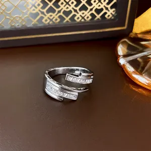 Detailed close-up of a silver-plated geometric open ring with sparkling baguette zircons