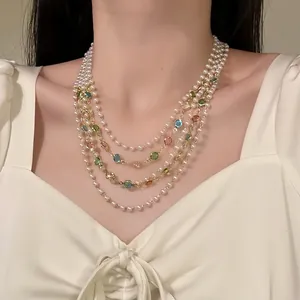 Detailed close-up of a French vintage multi-layer pearl necklace with colorful gemstones