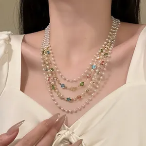 Close-up detail of a French retro multi-layer pearl necklace with colorful gemstones