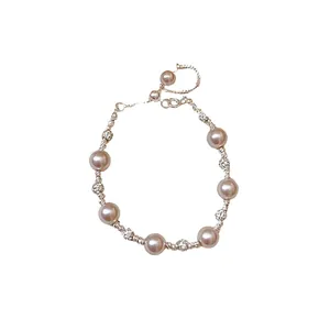 Elegant French style pearl and zircon bracelet with silver chain on white background