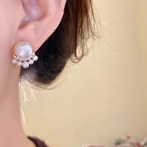 Primer plano de elegantes pendientes de perlas vintage francesas con diamantes de imitación.