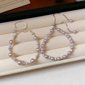 Elegant French style purple pearl and zircon bracelets displayed in a jewelry tray