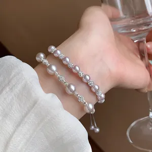 Elegant detail of pearl and zircon bracelets on wrist with a minimalist aesthetic