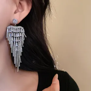 Close-up of sparkling zircon fringe tassel earrings on a model for gala evening events