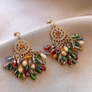Detailed close-up of Bohemian fan-shaped earrings with colorful crystal tassels.